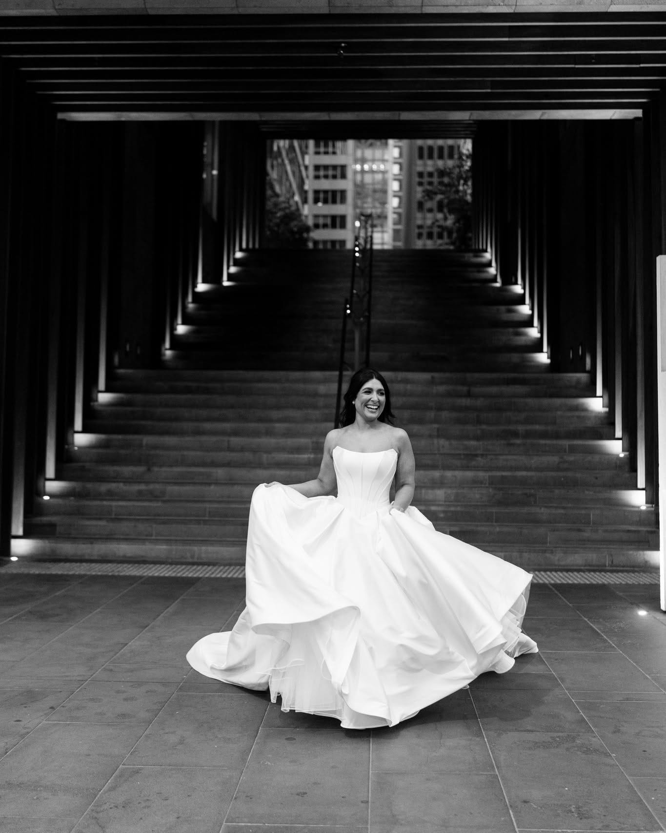 Bride in a long-train gown in a heritage colonnade — Melbourne wedding photography